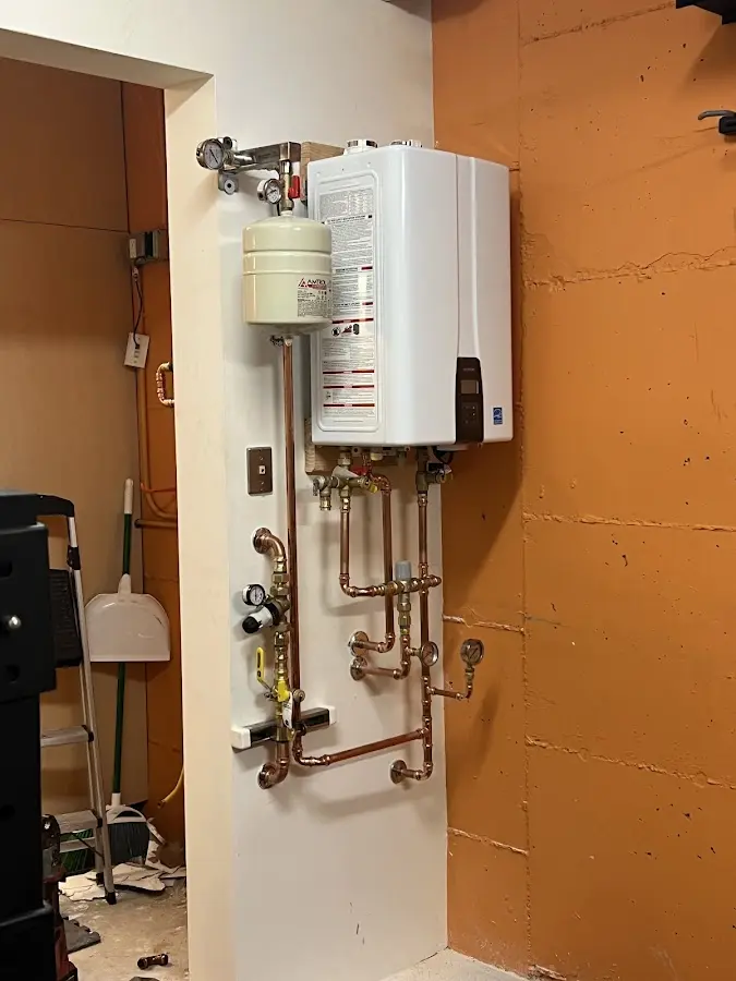 Plumbing technician inspecting water heater connections in Spanish Fork